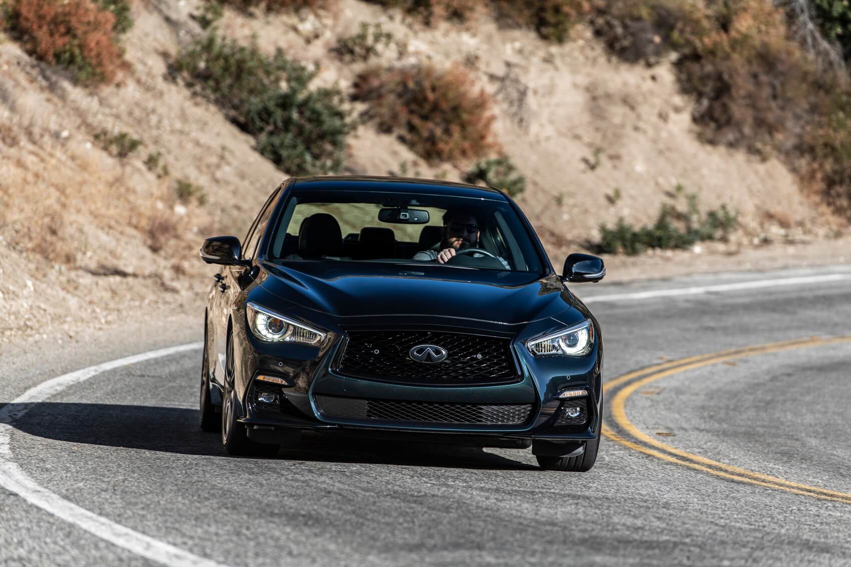 INFINITI Q50 driving on desert highway