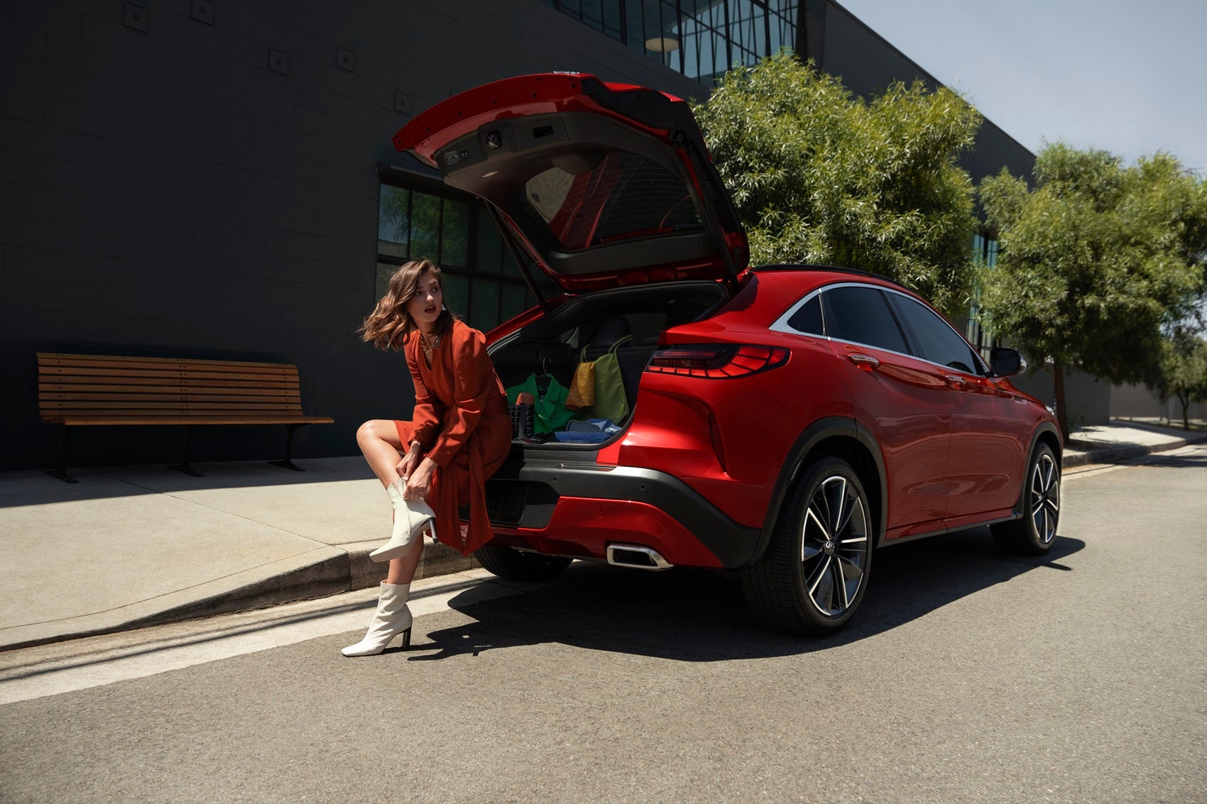 Woman sitting in the trunk of INFINITI QX55