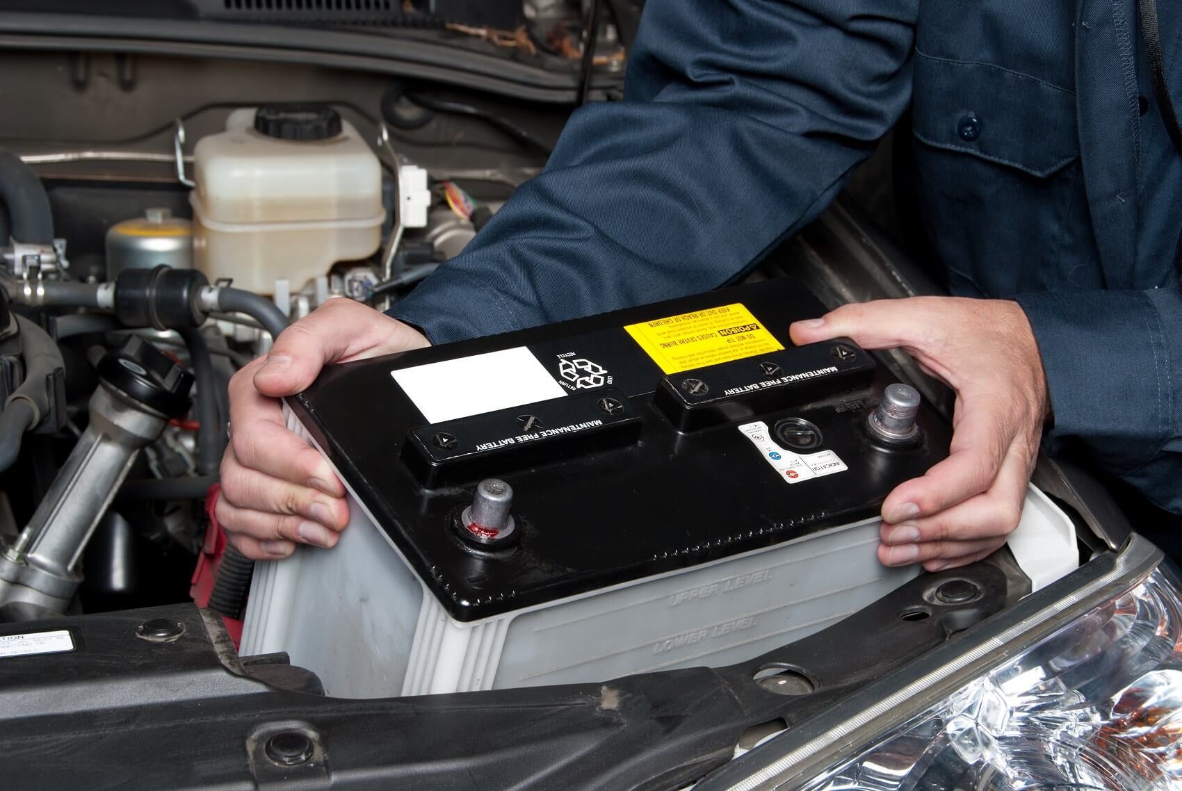 Mechanic replacing battery during battery service near Kingston MA