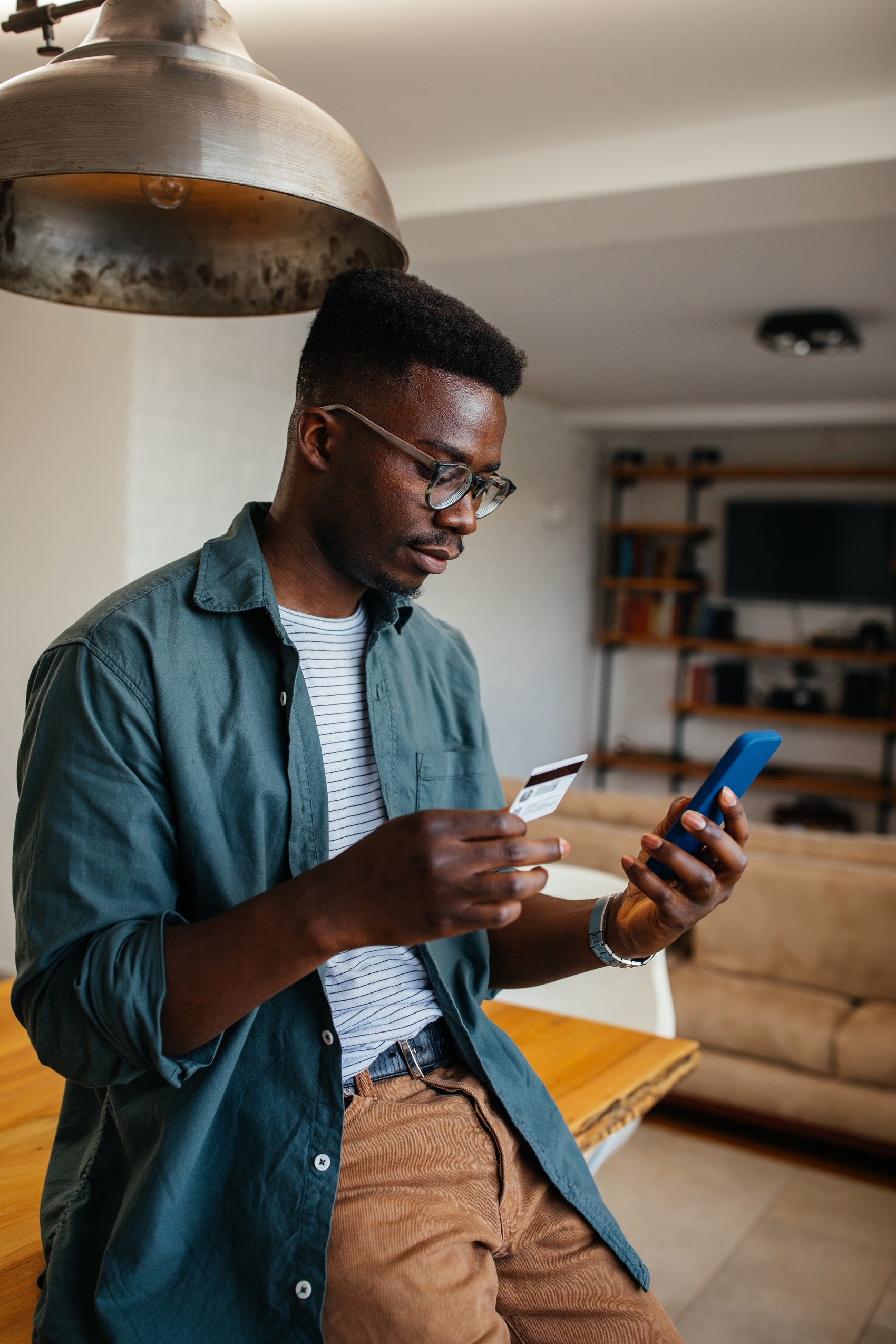 Man holding credit card and phone