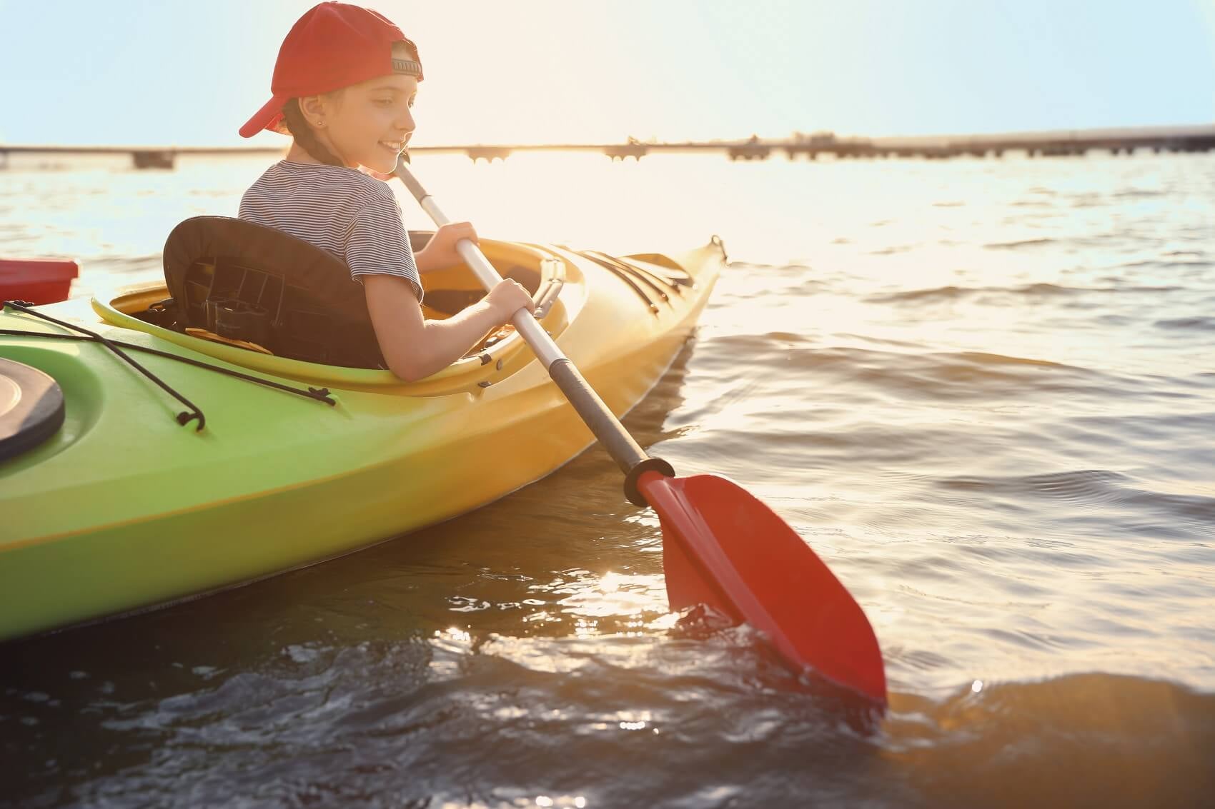 lifestyle shot of girl in kayak on the bay