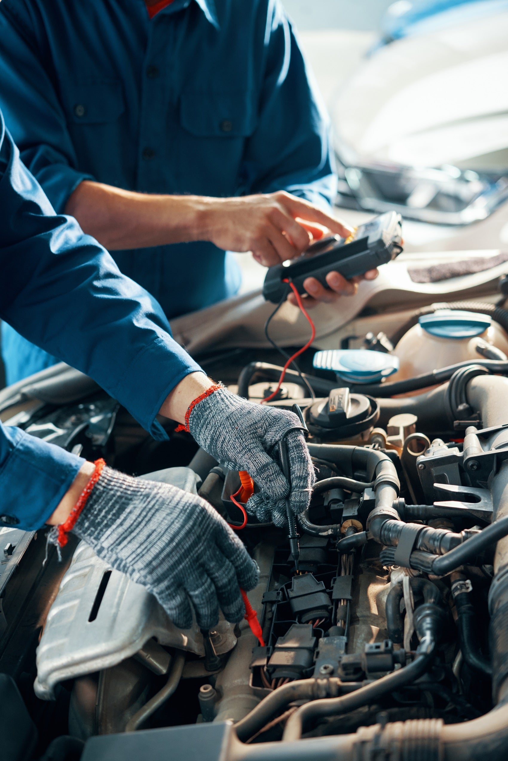 Technicians working on car battery